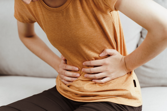 Young woman suffering from strong abdominal pain